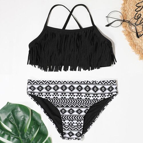Zweiteiliger Bikini mit Fransen-Oberteil und gemustertem Unterteil, daneben Sonnenbrille und Strohhut.